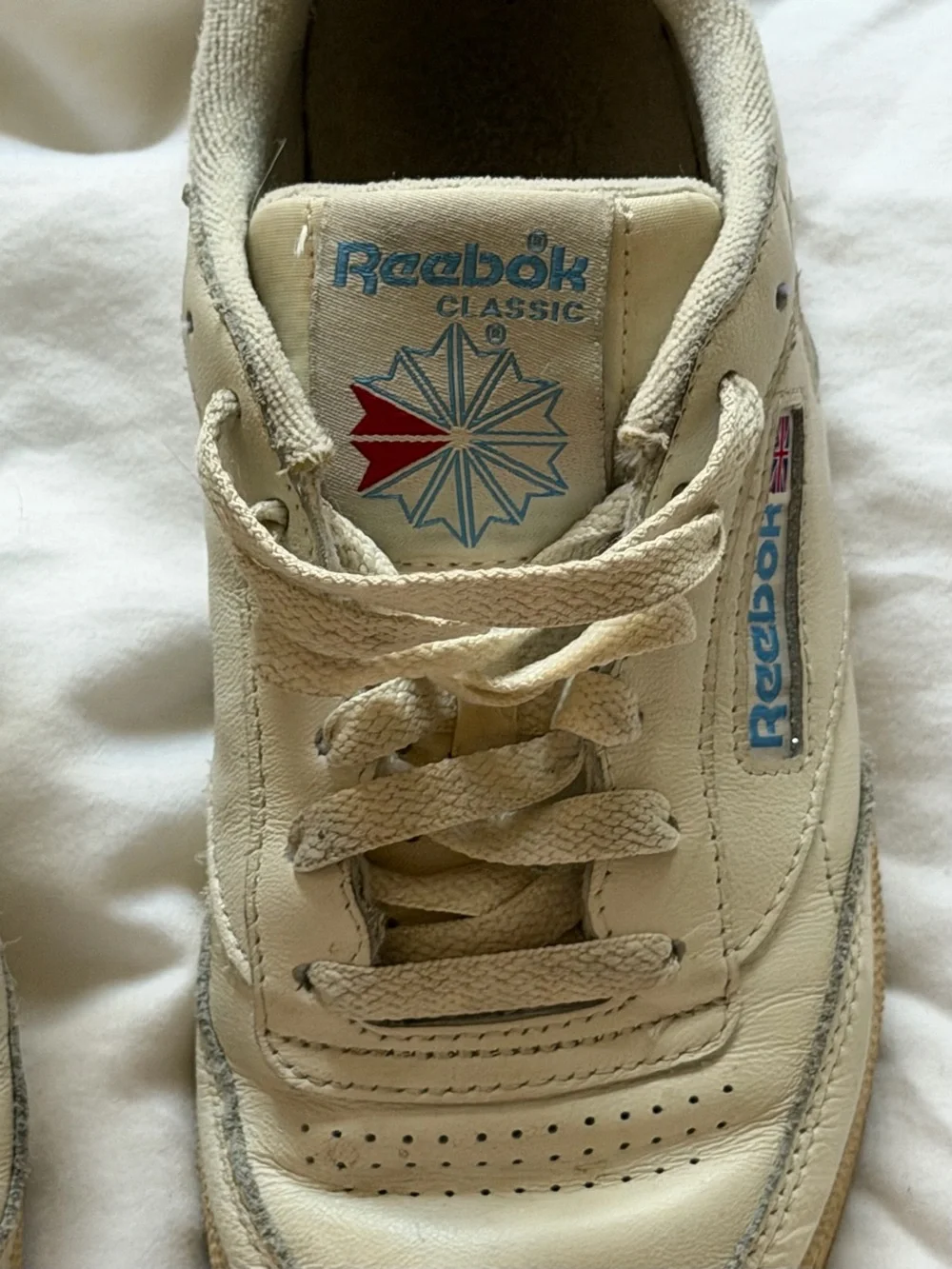 Reebok Kids Classic Leather Sneaker in Off-White with Blue and Red Accents